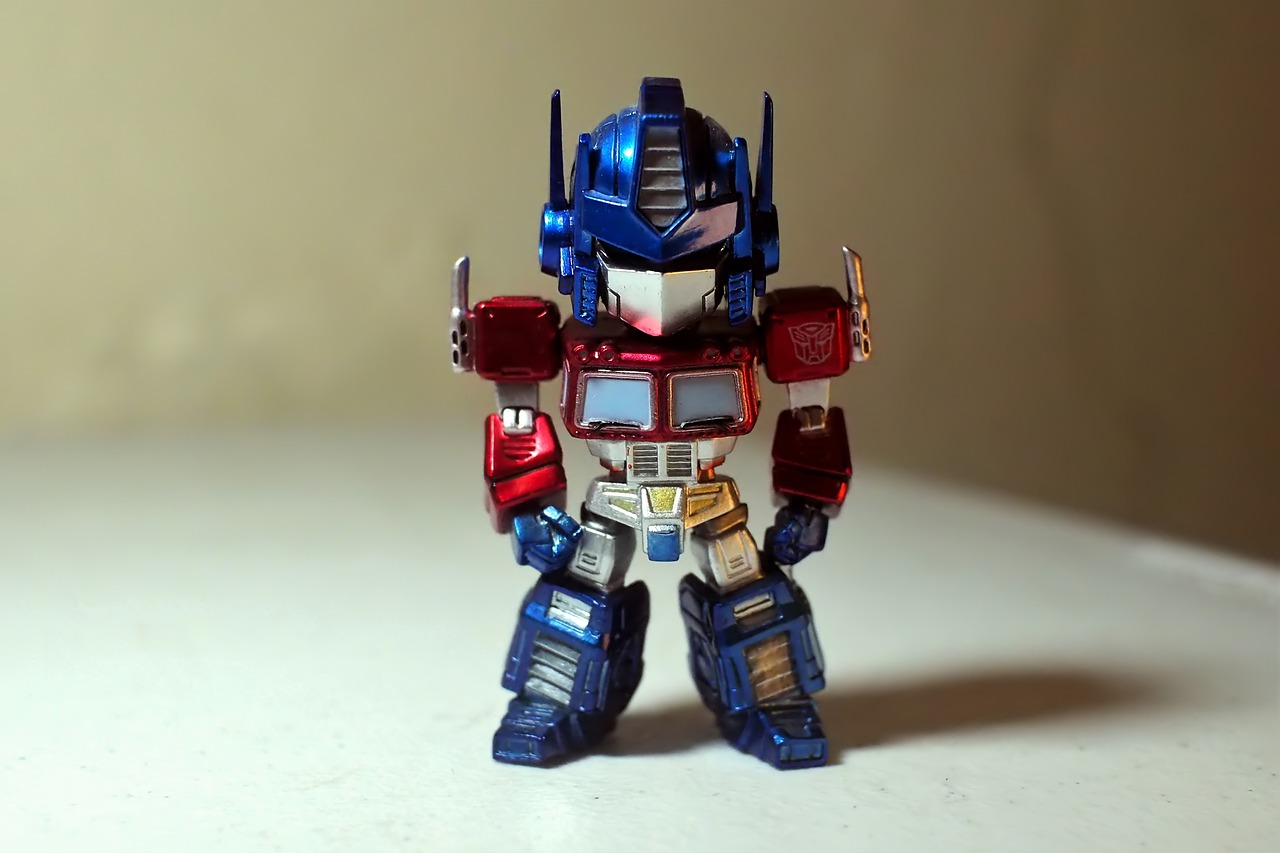 Small blue and red toy robot standing in front of a beige wall, symbolising the Cookiebot consent tool